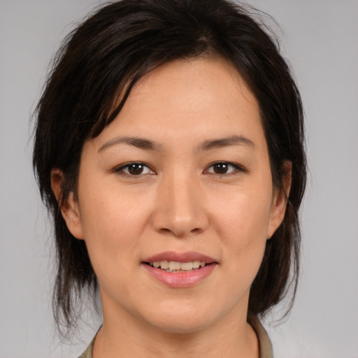 Joyful asian young-adult female with medium  brown hair and brown eyes