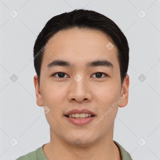 Joyful asian young-adult male with short  black hair and brown eyes