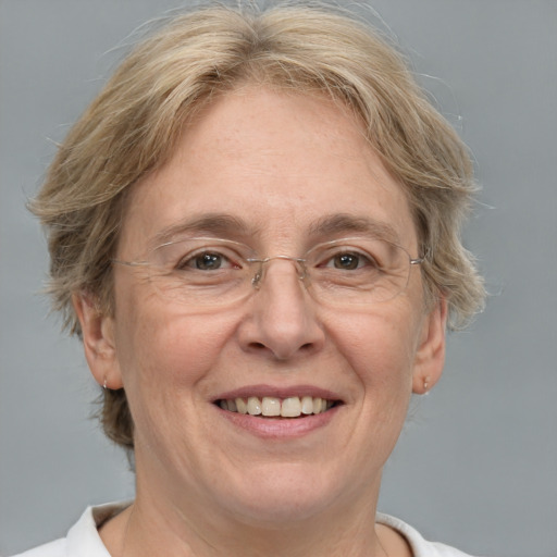 Joyful white middle-aged female with medium  blond hair and grey eyes