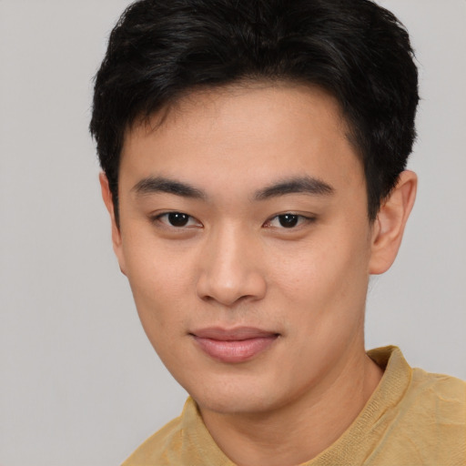 Joyful asian young-adult male with short  brown hair and brown eyes
