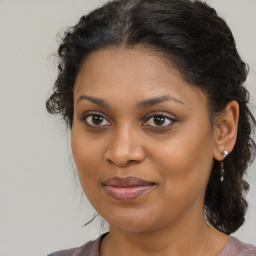 Joyful black young-adult female with medium  brown hair and brown eyes