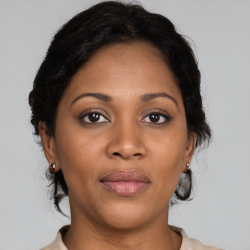 Joyful black young-adult female with medium  black hair and brown eyes