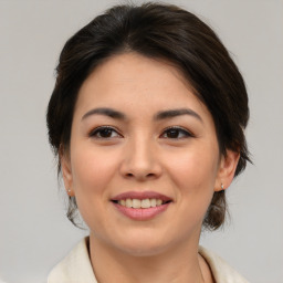 Joyful asian young-adult female with medium  brown hair and brown eyes