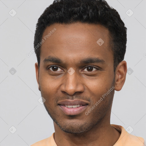 Joyful black young-adult male with short  brown hair and brown eyes