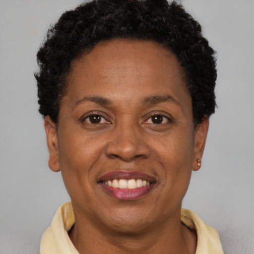 Joyful black adult female with short  brown hair and brown eyes