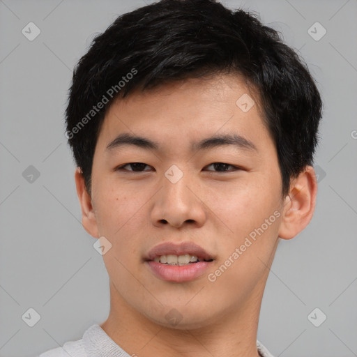 Joyful asian young-adult male with short  black hair and brown eyes