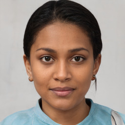 Joyful latino young-adult female with short  brown hair and brown eyes