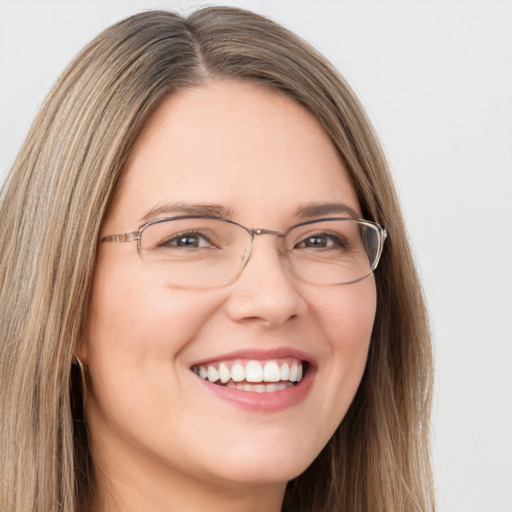 Joyful white young-adult female with long  brown hair and green eyes