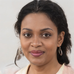 Joyful black young-adult female with medium  brown hair and brown eyes