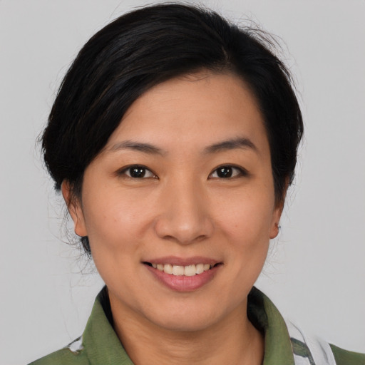 Joyful asian young-adult female with medium  brown hair and brown eyes
