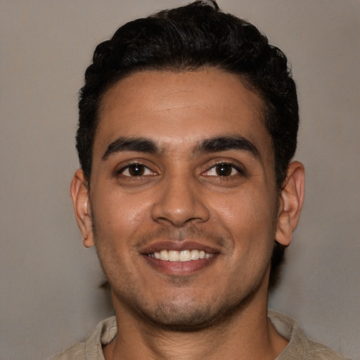 Joyful white young-adult male with short  black hair and brown eyes