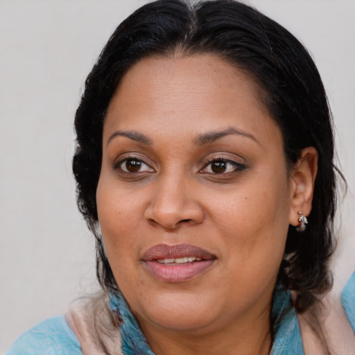 Joyful black adult female with medium  brown hair and brown eyes
