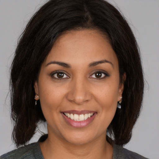 Joyful white young-adult female with medium  brown hair and brown eyes