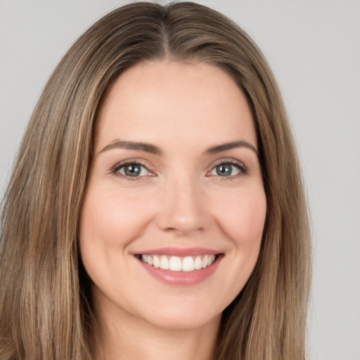 Joyful white young-adult female with long  brown hair and brown eyes