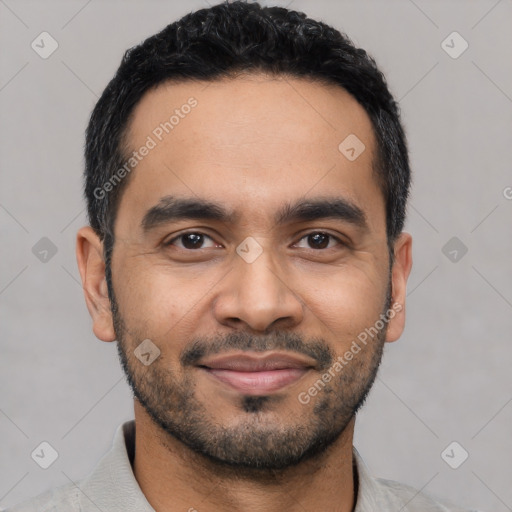 Joyful latino young-adult male with short  black hair and brown eyes