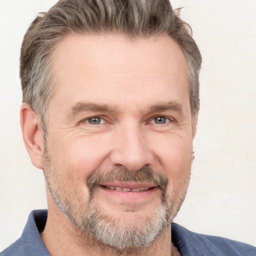 Joyful white adult male with short  brown hair and grey eyes