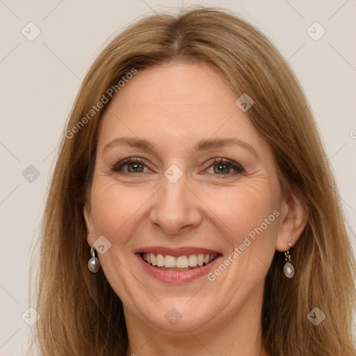 Joyful white adult female with long  brown hair and grey eyes