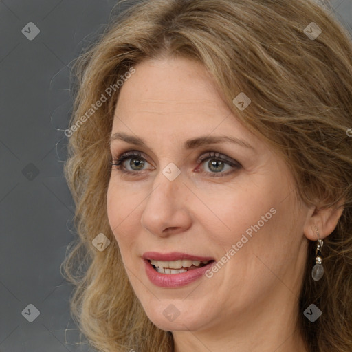 Joyful white adult female with long  brown hair and brown eyes