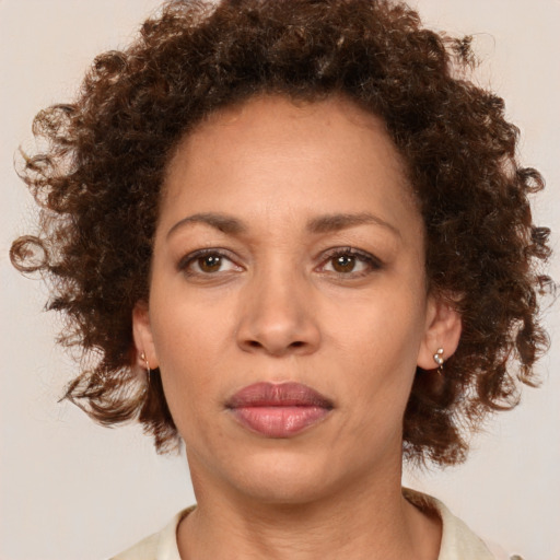 Neutral black young-adult female with medium  brown hair and brown eyes