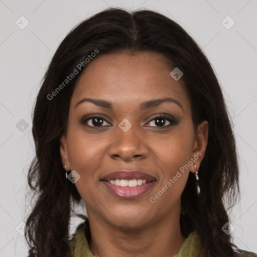 Joyful black young-adult female with long  brown hair and brown eyes