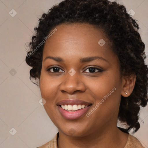 Joyful black young-adult female with long  brown hair and brown eyes