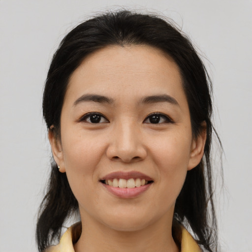 Joyful latino young-adult female with medium  brown hair and brown eyes