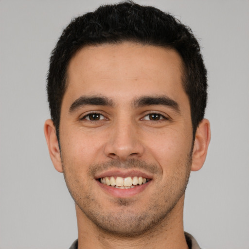 Joyful white young-adult male with short  brown hair and brown eyes