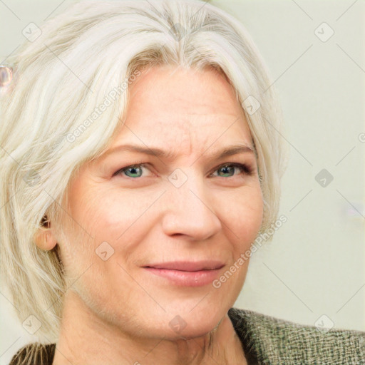 Joyful white adult female with medium  blond hair and blue eyes