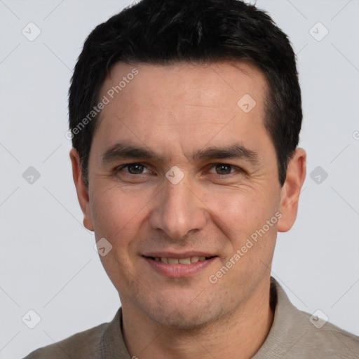 Joyful white adult male with short  black hair and brown eyes