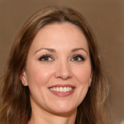 Joyful white adult female with long  brown hair and brown eyes