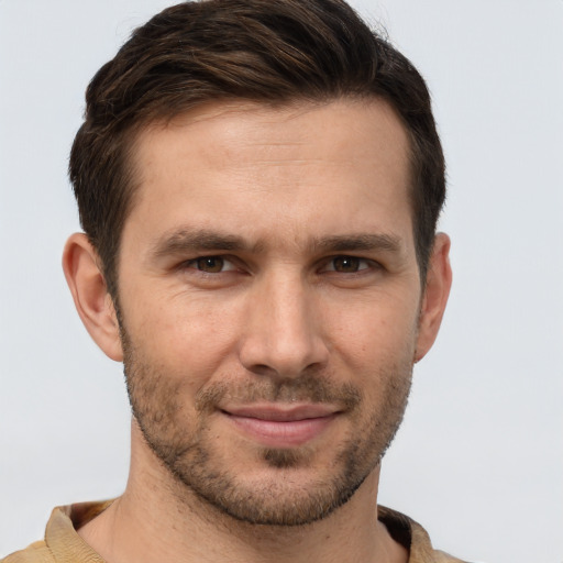 Joyful white young-adult male with short  brown hair and brown eyes