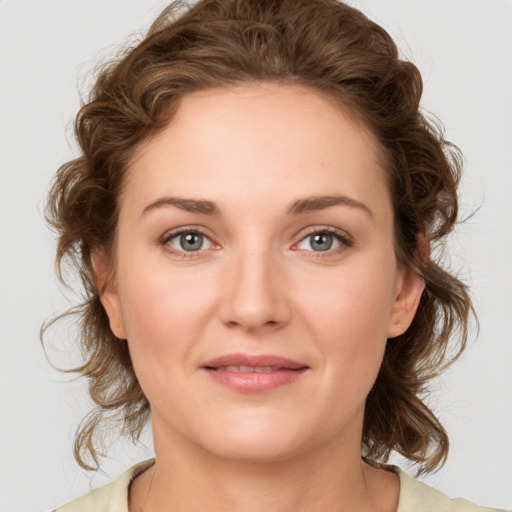 Joyful white young-adult female with medium  brown hair and green eyes