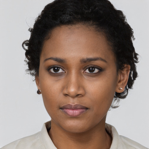 Neutral black young-adult female with short  black hair and brown eyes