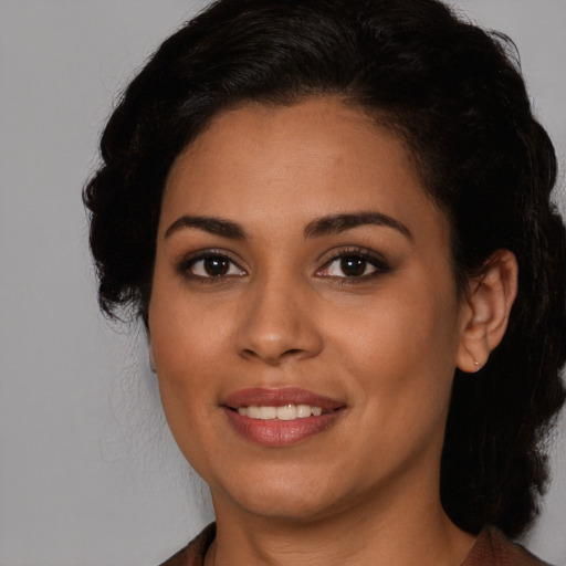 Joyful latino young-adult female with medium  brown hair and brown eyes