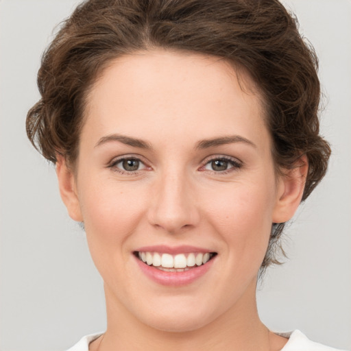 Joyful white young-adult female with medium  brown hair and green eyes