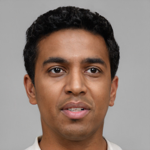 Joyful latino young-adult male with short  black hair and brown eyes