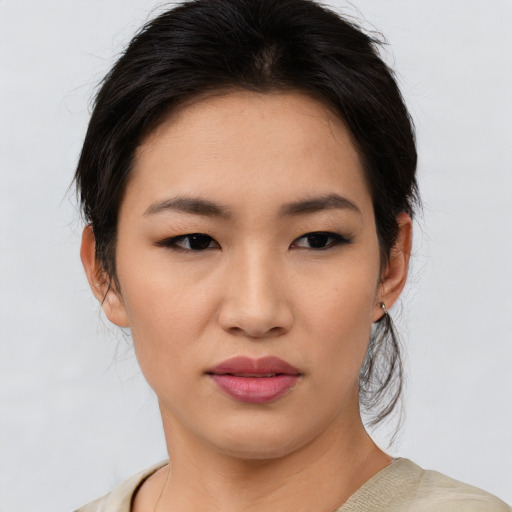 Joyful asian young-adult female with medium  brown hair and brown eyes