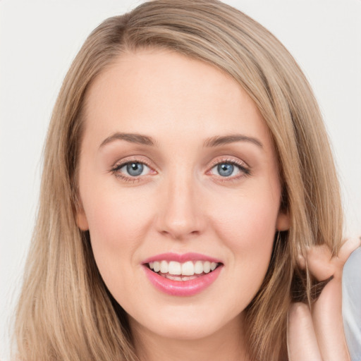 Joyful white young-adult female with long  brown hair and green eyes