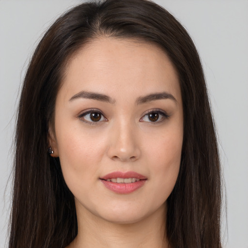 Joyful asian young-adult female with long  brown hair and brown eyes