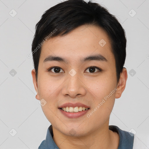 Joyful asian young-adult male with short  black hair and brown eyes