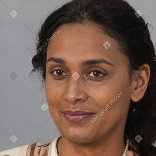 Joyful latino adult female with medium  brown hair and brown eyes