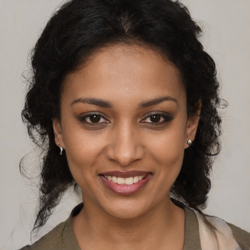 Joyful black young-adult female with medium  brown hair and brown eyes