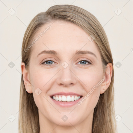 Joyful white young-adult female with long  brown hair and blue eyes