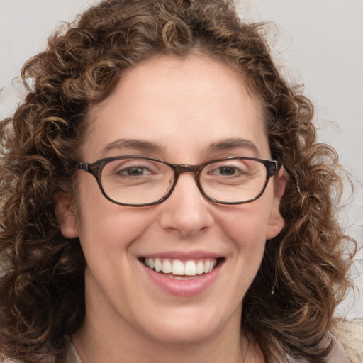 Joyful white young-adult female with medium  brown hair and green eyes