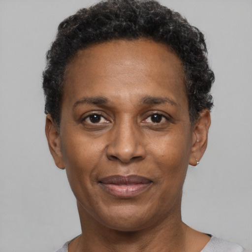 Joyful black adult female with short  black hair and brown eyes