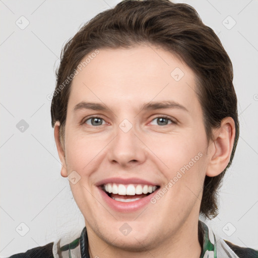 Joyful white young-adult female with medium  brown hair and grey eyes