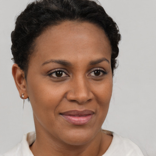 Joyful black young-adult female with short  brown hair and brown eyes
