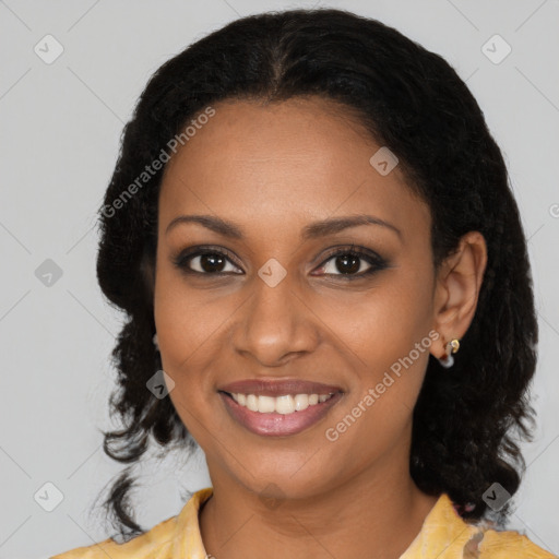 Joyful black young-adult female with long  brown hair and brown eyes