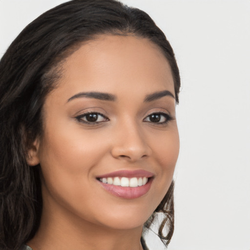 Joyful latino young-adult female with long  brown hair and brown eyes