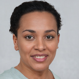 Joyful latino young-adult female with short  brown hair and brown eyes